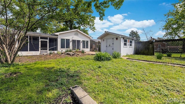 912 Salem Way, Ellisville, MO 63021 - rear view of property featuring a sunroom, a storage shed, and an outbuilding