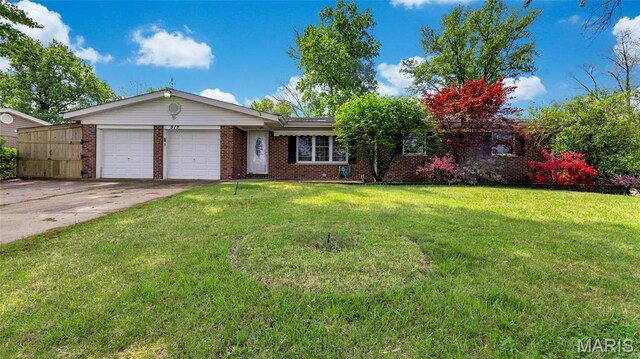 912 Salem Way, Ellisville, MO 63021 - ranch-style house featuring a garage, brick siding, concrete driveway, and a front lawn