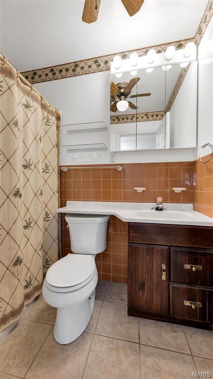 912 Salem Way, Ellisville, MO 63021 - bathroom with ceiling fan, tile walls, vanity, toilet, and tile patterned floors