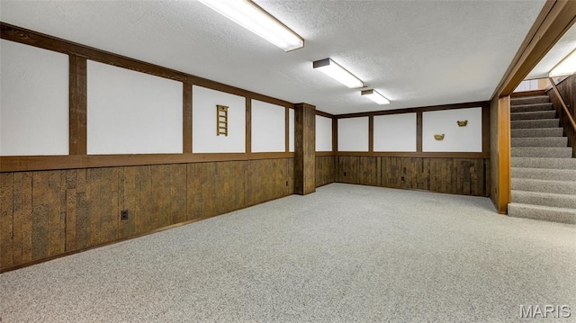 912 Salem Way, Ellisville, MO 63021 - carpeted spare room with a textured ceiling, stairs, and wooden walls