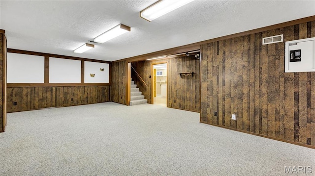 912 Salem Way, Ellisville, MO 63021 - finished basement featuring stairs, wood walls, a textured ceiling, and carpet floors