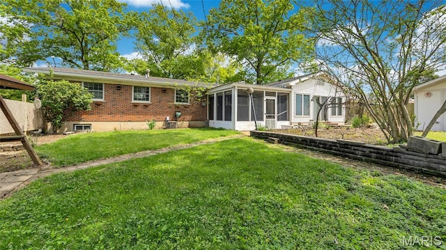 912 Salem Way, Ellisville, MO 63021 - rear view of house featuring a sunroom, a yard, and brick siding