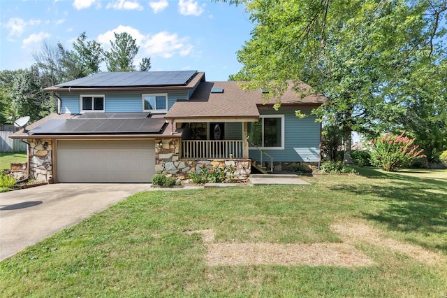 split level home featuring solar panels, a front lawn, driveway, and covered porch
