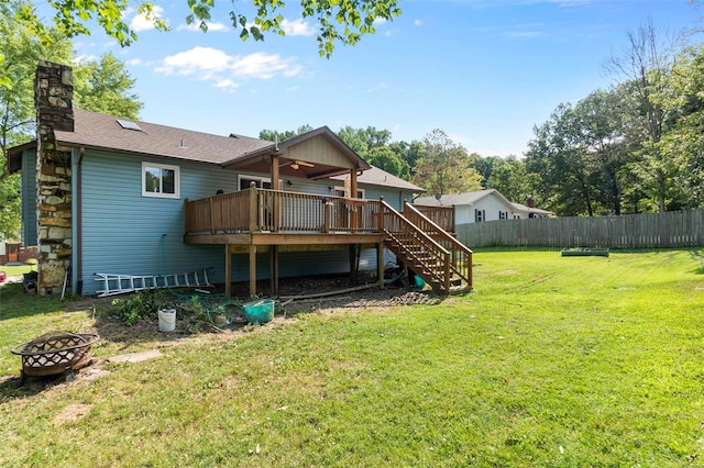 rear view of property with an outdoor fire pit, a deck, ceiling fan, stairs, and a chimney