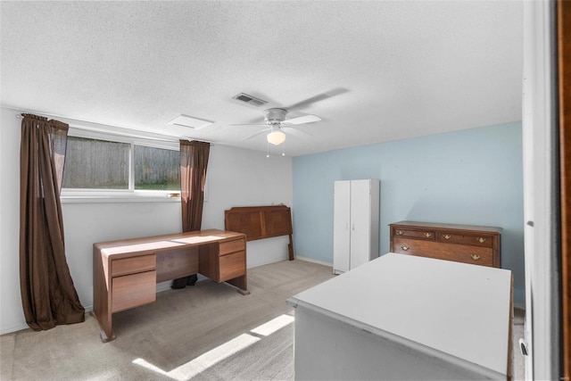 unfurnished bedroom with light colored carpet, a textured ceiling, ceiling fan, and an office area