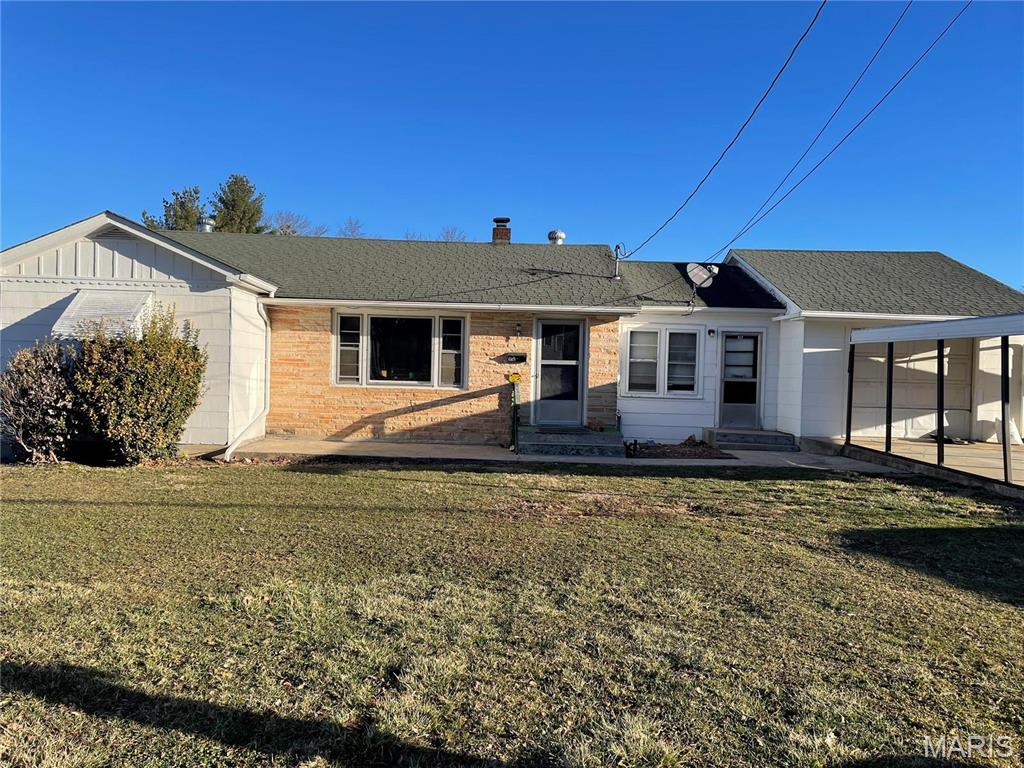 812 E Scenic Rivers Blvd, Salem, MO 65560 - back of property featuring a carport, a yard, and a chimney