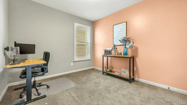 carpeted home office featuring baseboards