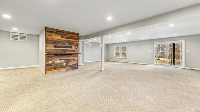 below grade area featuring light colored carpet, recessed lighting, and baseboards