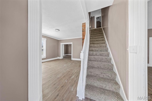 307 S State Highway 47, Warrenton, MO 63383 - stairway with wood finished floors, baseboards, ornamental molding, and a textured ceiling