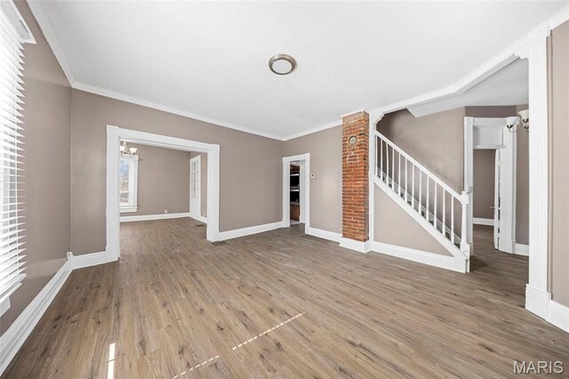307 S State Highway 47, Warrenton, MO 63383 - unfurnished living room featuring a chandelier, stairway, wood finished floors, baseboards, and ornamental molding