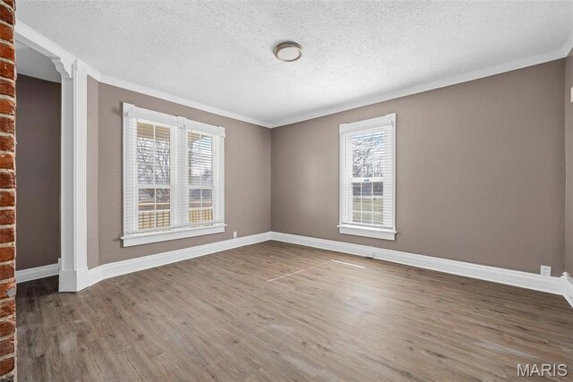 307 S State Highway 47, Warrenton, MO 63383 - empty room featuring a textured ceiling, wood finished floors, ornamental molding, and baseboards