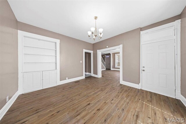 307 S State Highway 47, Warrenton, MO 63383 - unfurnished dining area featuring a chandelier, wood-type flooring, and baseboards