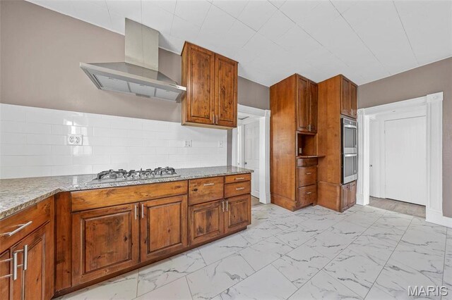 307 S State Highway 47, Warrenton, MO 63383 - kitchen featuring wall chimney exhaust hood, light marble finish floors, brown cabinetry, appliances with stainless steel finishes, and light stone countertops
