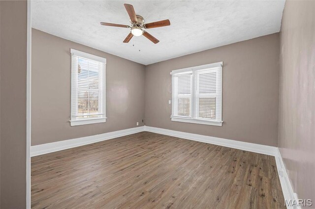 307 S State Highway 47, Warrenton, MO 63383 - empty room with wood finished floors, baseboards, and a ceiling fan