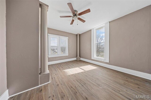 307 S State Highway 47, Warrenton, MO 63383 - empty room with wood finished floors, a ceiling fan, ornate columns, and baseboards