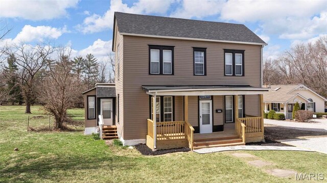 307 S State Highway 47, Warrenton, MO 63383 - traditional-style home featuring covered porch, a front lawn, and roof with shingles