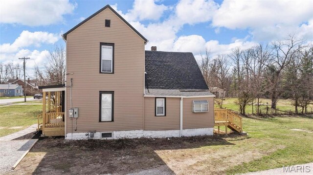 307 S State Highway 47, Warrenton, MO 63383 - view of side of home featuring a yard and a shingled roof