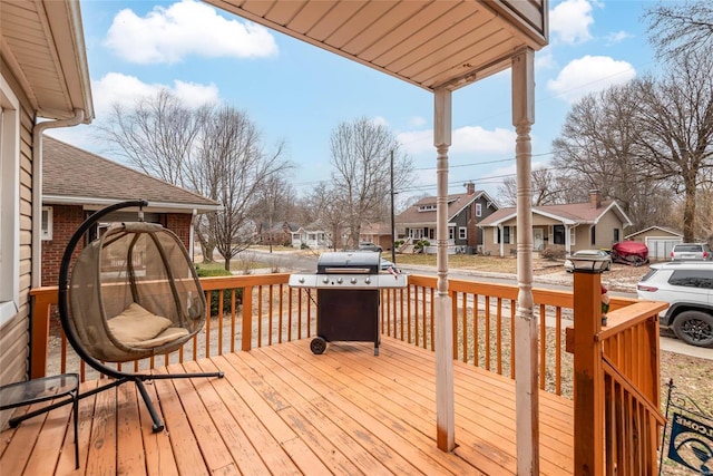 wooden terrace featuring a residential view and area for grilling
