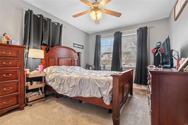 bedroom with light colored carpet and a ceiling fan