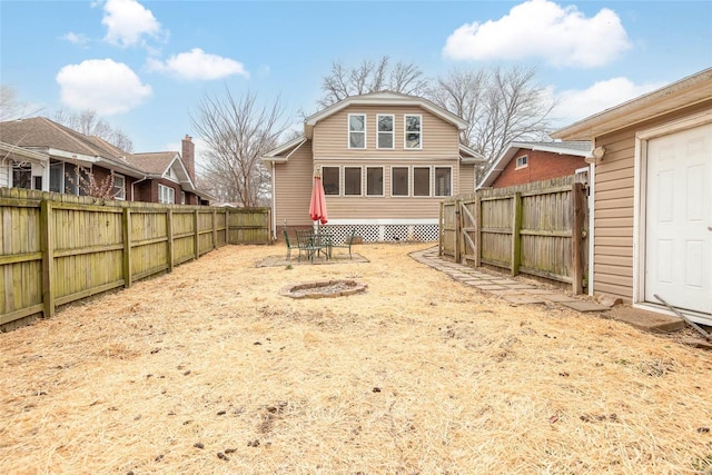 rear view of property featuring a fenced backyard