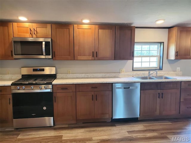19983 Oak Dr, Carlyle, IL 62231 - kitchen with stainless steel appliances, a sink, light countertops, light wood finished floors, and recessed lighting