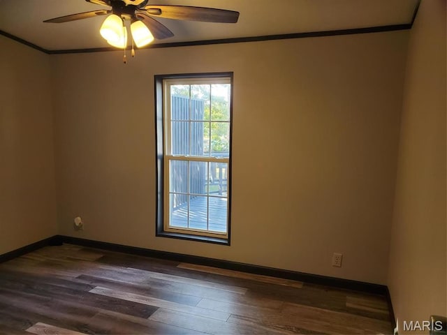 19983 Oak Dr, Carlyle, IL 62231 - spare room featuring ornamental molding, dark wood-type flooring, baseboards, and ceiling fan