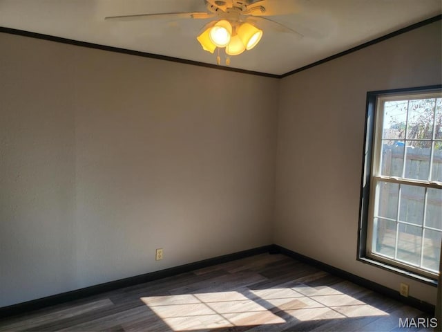 19983 Oak Dr, Carlyle, IL 62231 - empty room with dark wood-style floors, crown molding, baseboards, and a ceiling fan