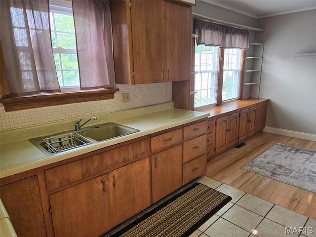 1450 Mulliken St, Carlyle, IL 62231 - kitchen with plenty of natural light, light countertops, a sink, crown molding, and backsplash