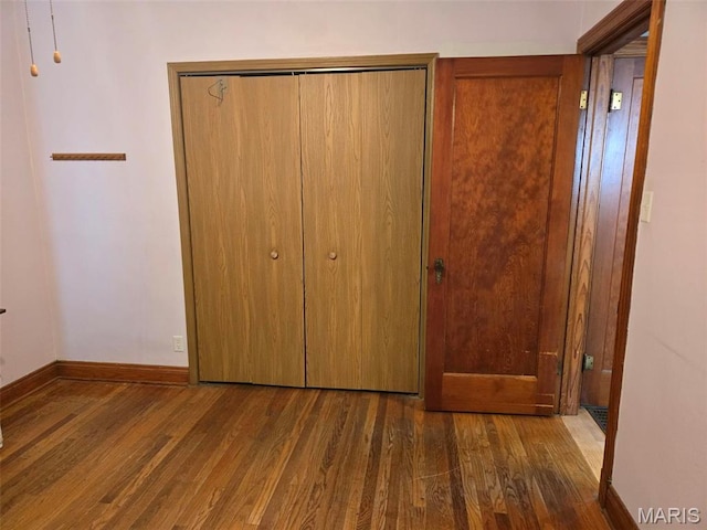 1450 Mulliken St, Carlyle, IL 62231 - unfurnished bedroom with wood finished floors and baseboards