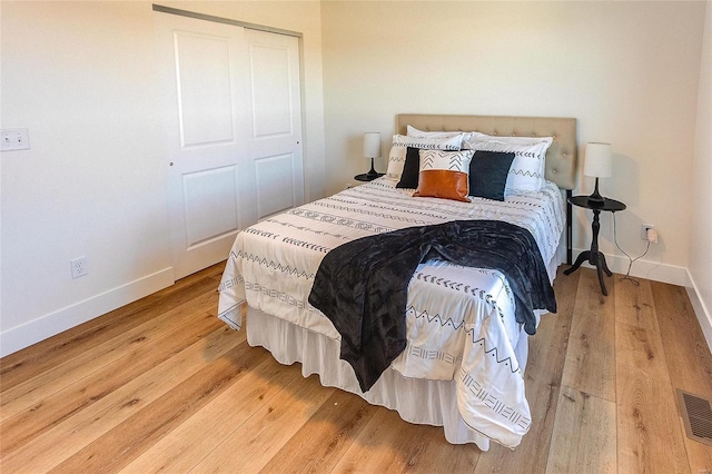 bedroom with baseboards and wood finished floors