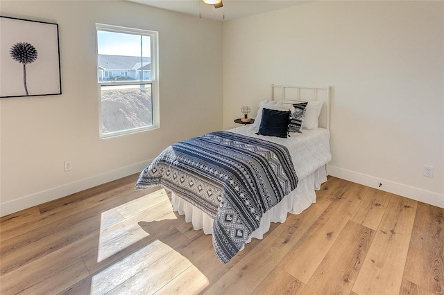 bedroom featuring baseboards and wood finished floors
