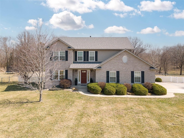 traditional home featuring brick siding and a shingled roof