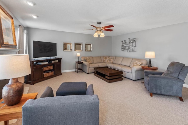 living room featuring ceiling fan, light carpet, and baseboards