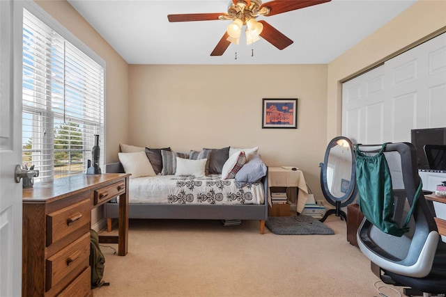 bedroom with carpet, an office area, and ceiling fan