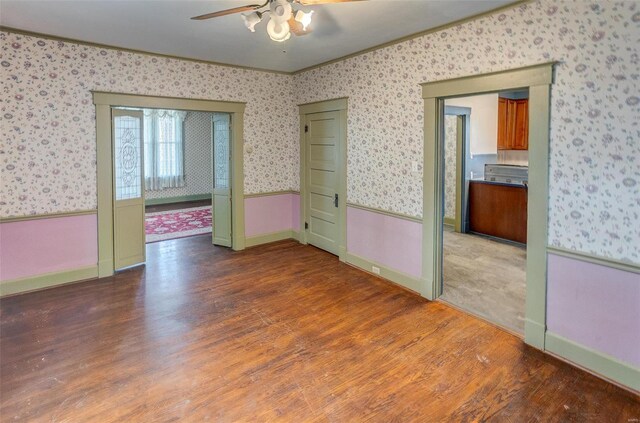 216 S Dickey St, Sparta, IL 62286 - unfurnished room featuring wallpapered walls, ceiling fan, wood finished floors, ornamental molding, and baseboards
