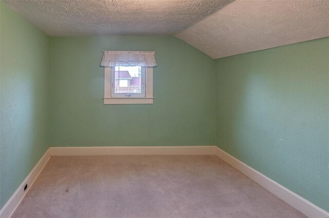 216 S Dickey St, Sparta, IL 62286 - additional living space featuring carpet floors, vaulted ceiling, a textured ceiling, and baseboards