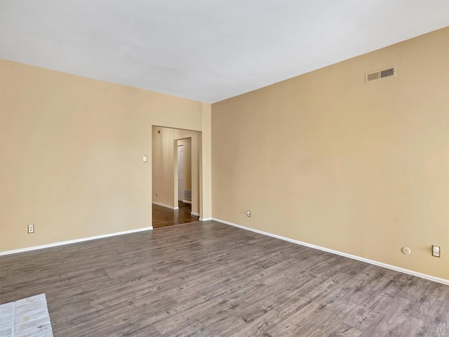 unfurnished room featuring dark wood finished floors and baseboards