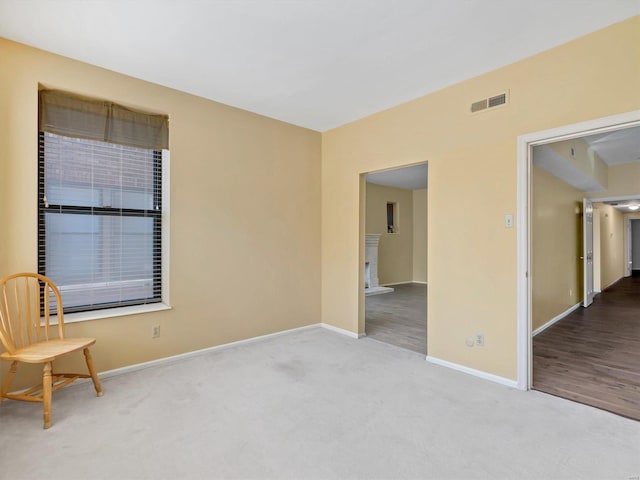 carpeted spare room featuring baseboards