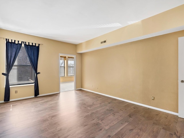 unfurnished room featuring wood finished floors and baseboards