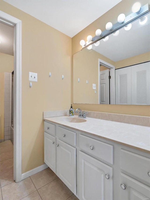 bathroom with tile patterned floors, vanity, and baseboards
