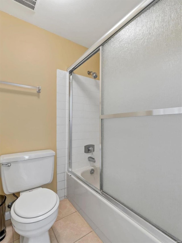 full bath with pet washing area, tile patterned floors, combined bath / shower with glass door, and toilet