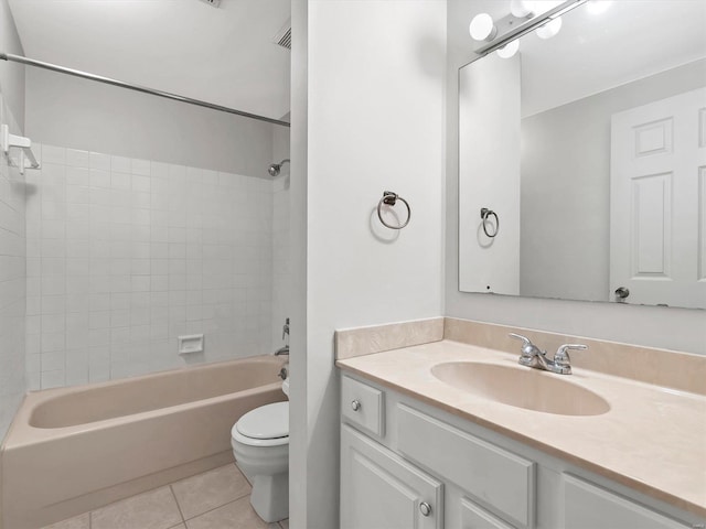 bathroom featuring tile patterned floors, toilet, bathing tub / shower combination, and vanity