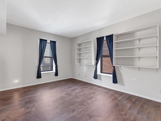 unfurnished room with wood finished floors and baseboards