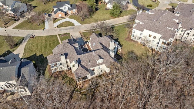 aerial view of property and surrounding area featuring nearby suburban area