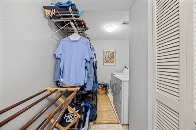 clothes washing area featuring washer and dryer