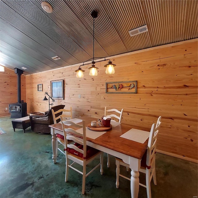 1432 Wayne 523, Wappapello, MO 63966 - dining area featuring a wood stove, wood walls, and concrete floors