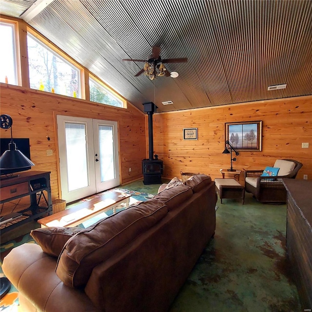 1432 Wayne 523, Wappapello, MO 63966 - living area with a wood stove, wooden walls, healthy amount of natural light, ceiling fan, and lofted ceiling