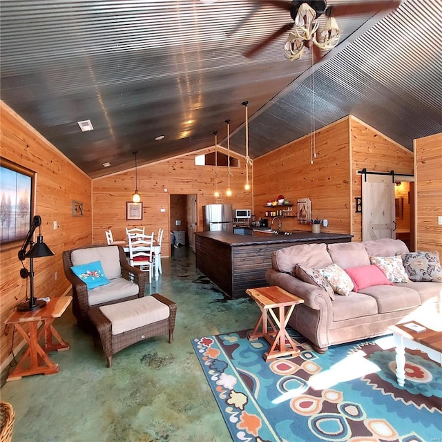 1432 Wayne 523, Wappapello, MO 63966 - living area with finished concrete floors, wood walls, lofted ceiling, and a barn door
