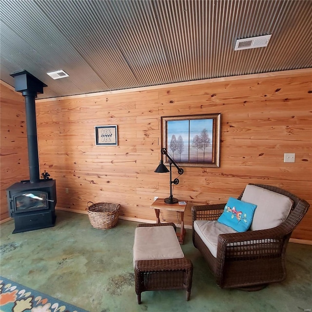 1432 Wayne 523, Wappapello, MO 63966 - living area featuring unfinished concrete flooring, wooden walls, and a wood stove