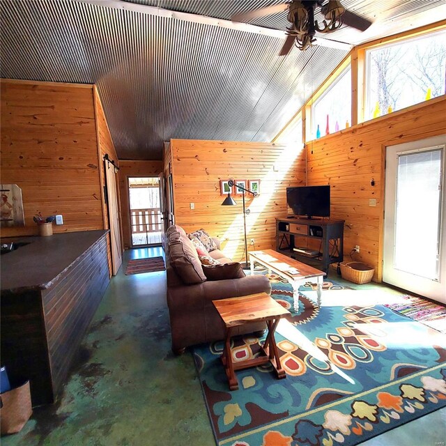 1432 Wayne 523, Wappapello, MO 63966 - living area with concrete flooring, lofted ceiling, wood walls, and ceiling fan